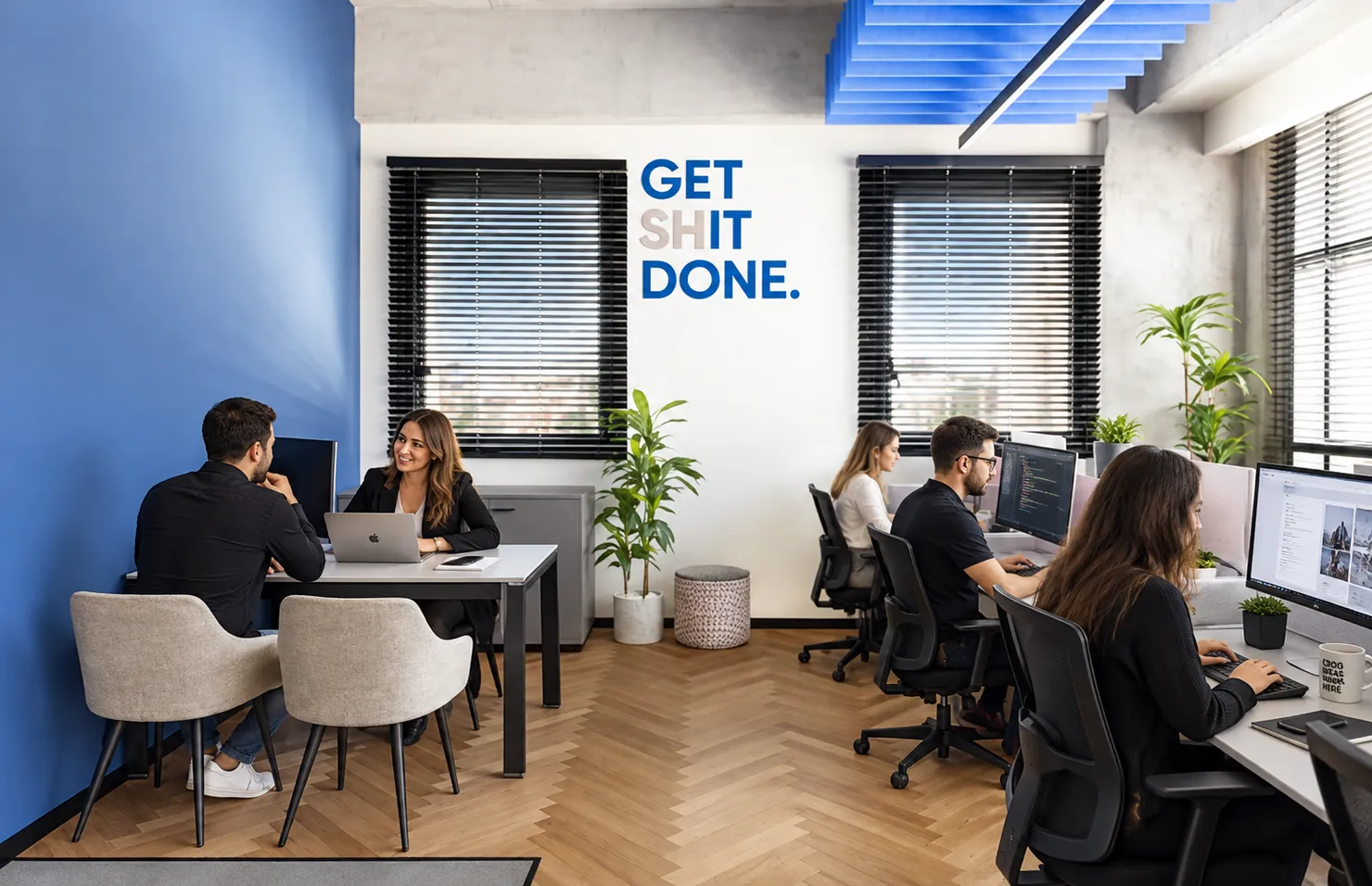 צוות דיגיטאץ׳ במשרד, על הקיר: GET SHIT DONE.